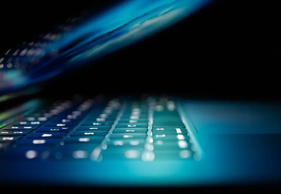 Illuminated laptop keyboard representing endpoint security and continuous cybersecurity vigilance